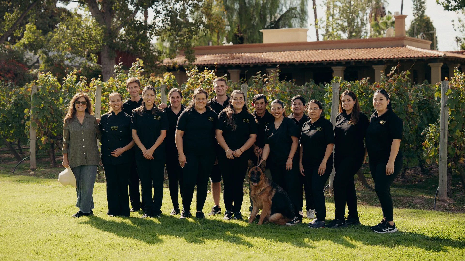The Finca Verde Oliva team, beside the estate's vineyard.