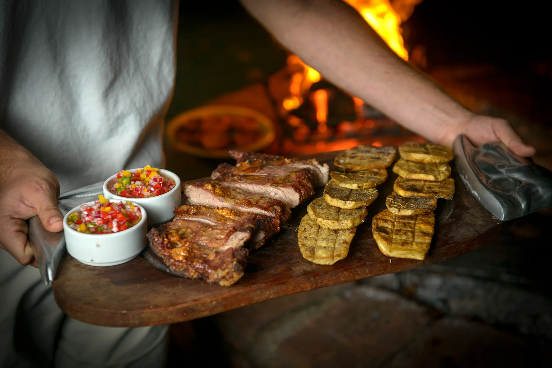 Board of ribs, roast potatoes and salsa criolla