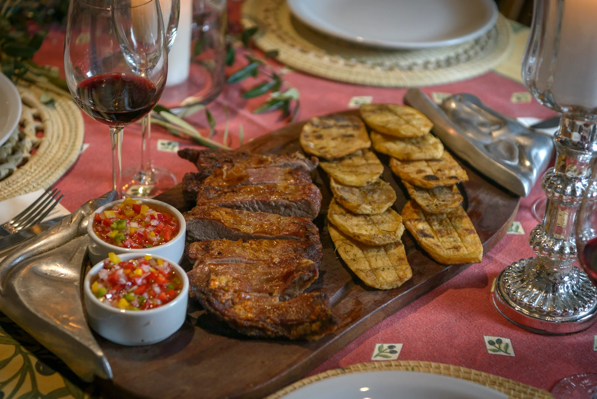 Board of flank steak with grilled potatoes and salsa criolla