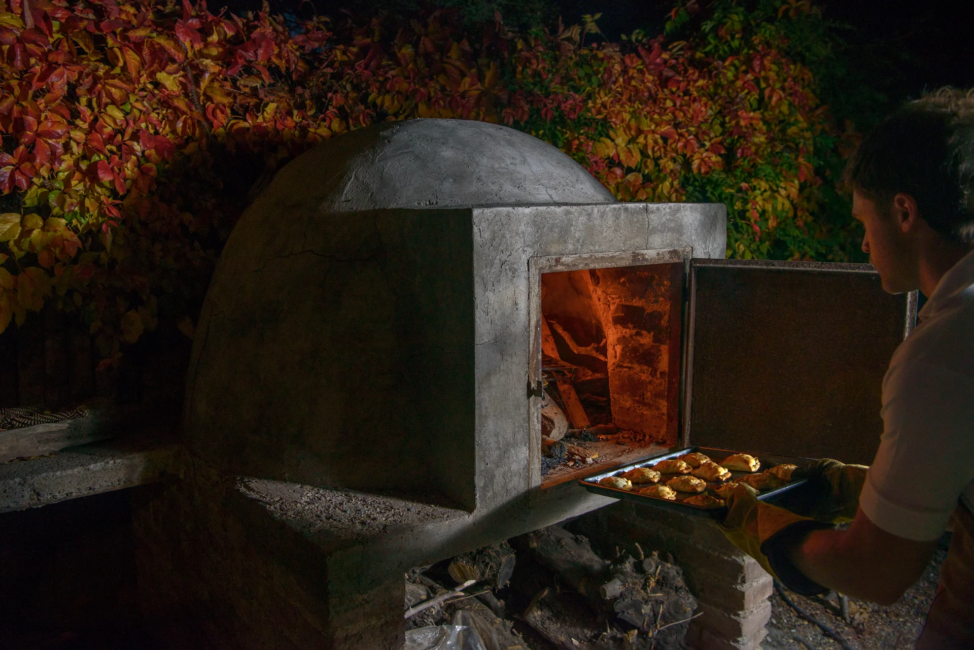 Empanadas going into the clay oven