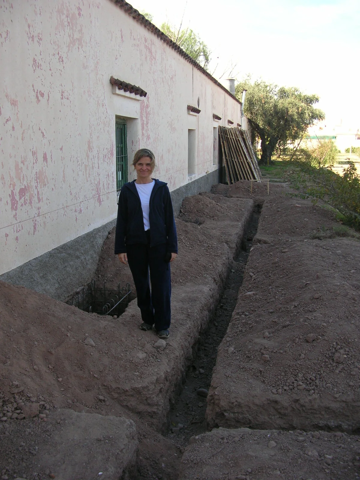 Julia beside the trenches at the beginning of the building work.