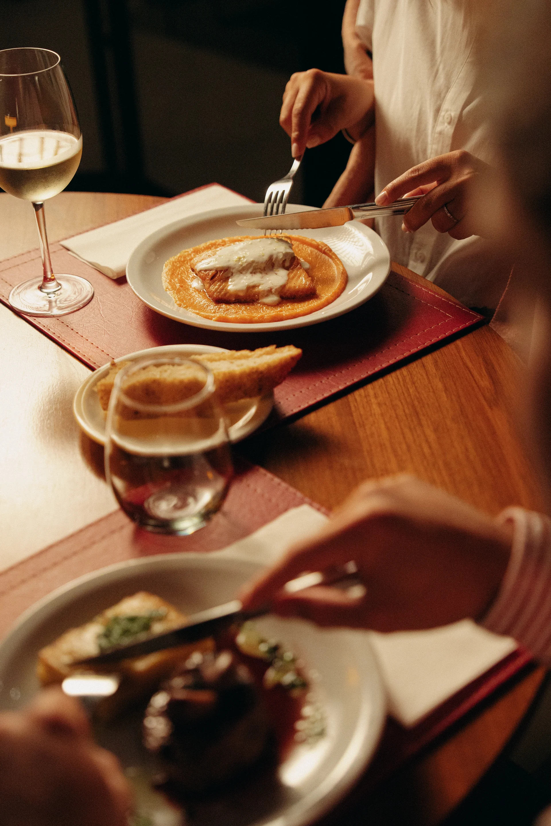 Salmon and beef being served at the table